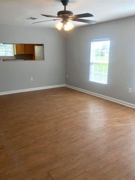 empty room featuring ceiling fan and hardwood / wood-style flooring