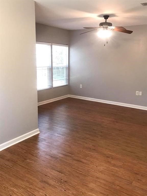 unfurnished room featuring ceiling fan and dark hardwood / wood-style flooring