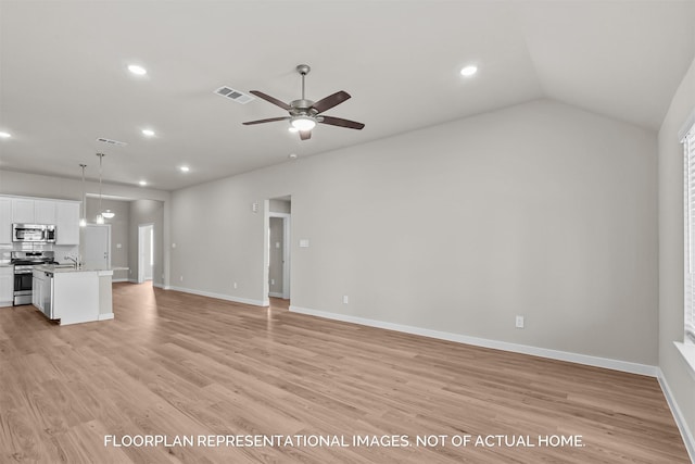 unfurnished living room with ceiling fan, light wood-type flooring, sink, and lofted ceiling