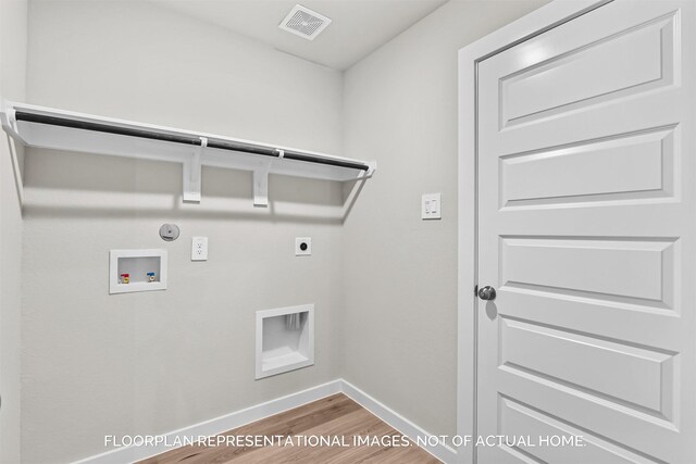 clothes washing area featuring washer hookup, hardwood / wood-style floors, gas dryer hookup, and electric dryer hookup