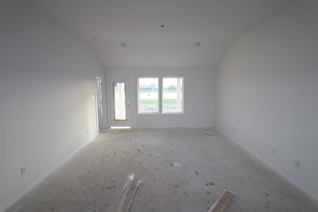 empty room featuring lofted ceiling