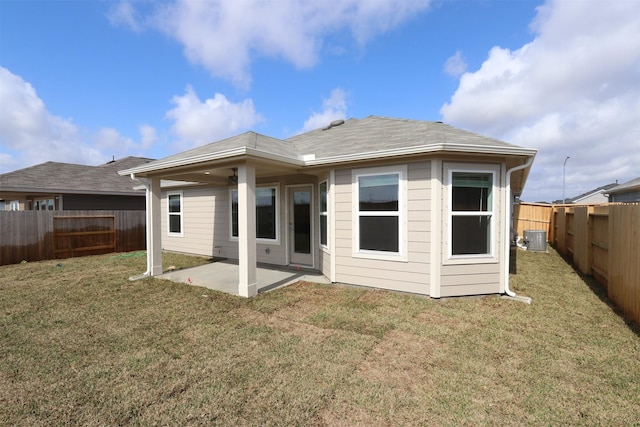 back of house featuring a patio area, a yard, a fenced backyard, and central air condition unit