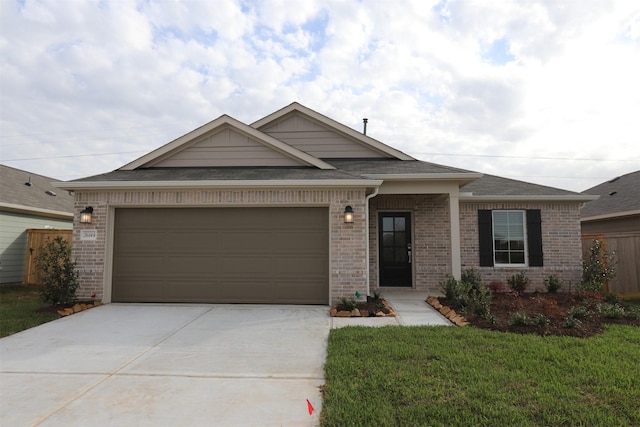 view of front of property with an attached garage, a front lawn, concrete driveway, and brick siding