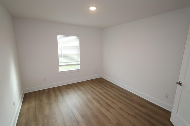 empty room featuring baseboards and wood finished floors