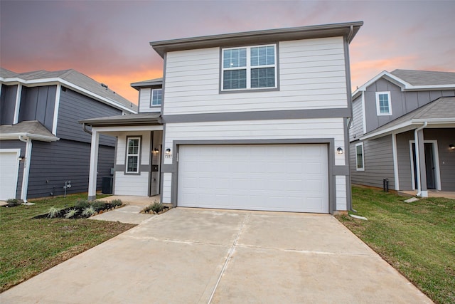 view of front property featuring a yard and a garage