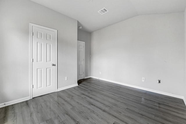 spare room with lofted ceiling and hardwood / wood-style flooring