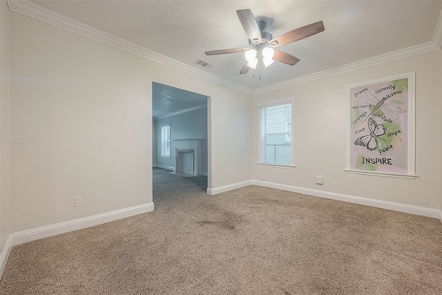 carpeted empty room featuring crown molding and ceiling fan