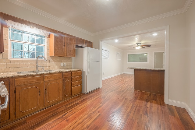 kitchen with sink, white fridge, dark wood-type flooring, and backsplash