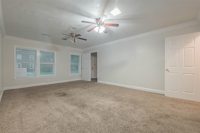 carpeted spare room with ornamental molding, a textured ceiling, and ceiling fan