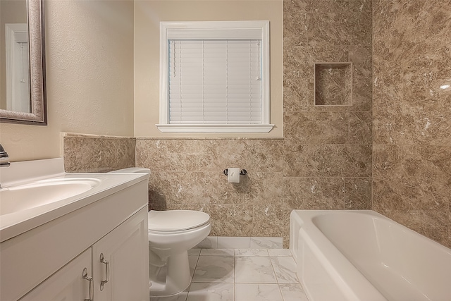 bathroom featuring tile walls, vanity, toilet, and a tub to relax in