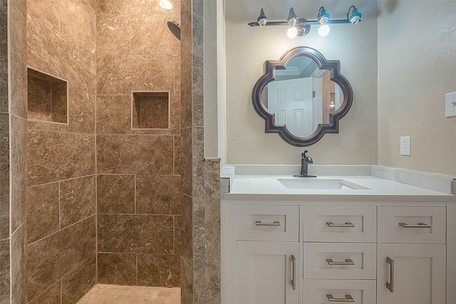 bathroom featuring vanity and a tile shower