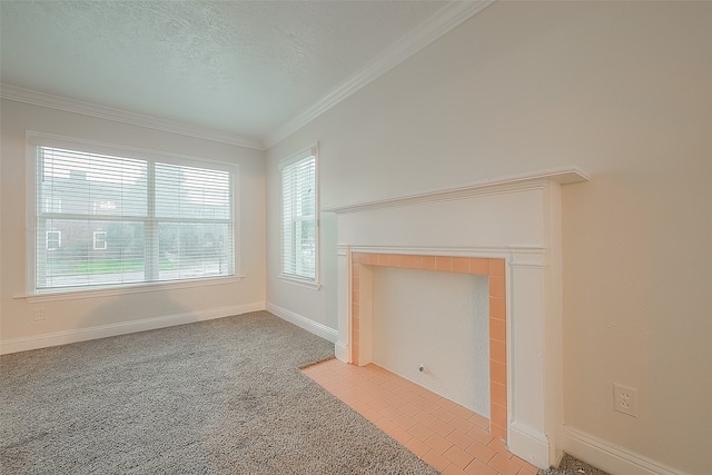 unfurnished living room with a wealth of natural light, ornamental molding, light carpet, and a fireplace