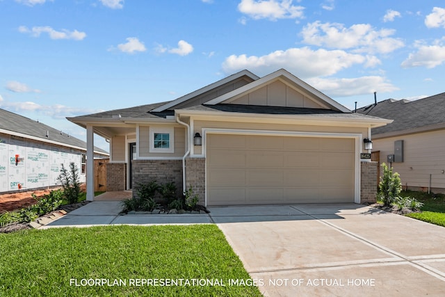 view of front of property with a front yard and a garage