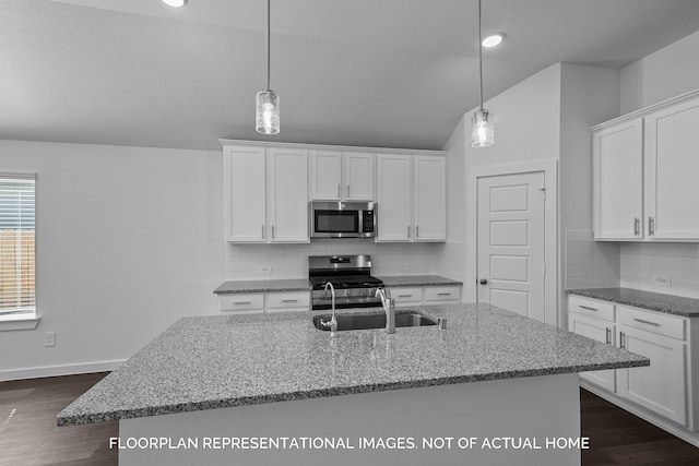 kitchen with stainless steel appliances, pendant lighting, white cabinetry, and sink