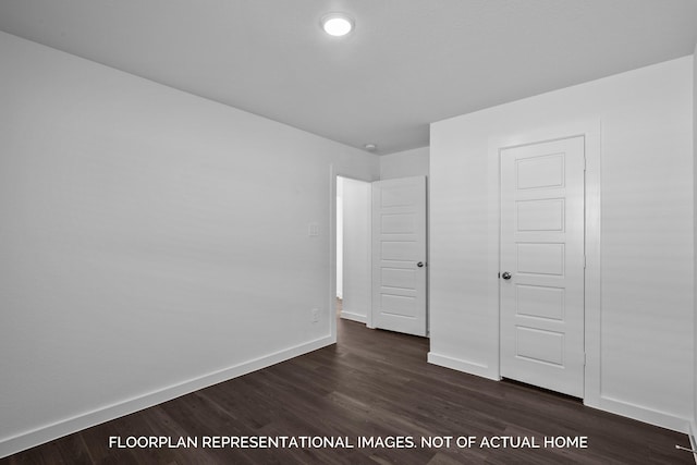 unfurnished bedroom featuring dark hardwood / wood-style flooring and a closet