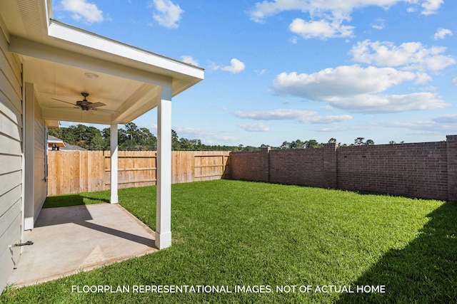 view of yard with ceiling fan and a patio area