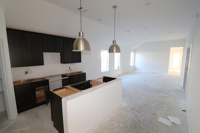 kitchen with vaulted ceiling and a center island