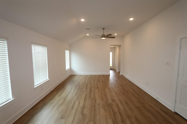 spare room featuring recessed lighting, vaulted ceiling, ceiling fan, light wood-type flooring, and baseboards