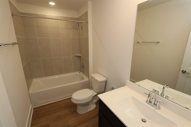 bathroom with vanity, shower / tub combination, wood finished floors, and toilet