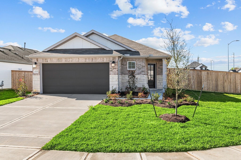 26200 Astral Way, La Marque, TX 77568 - ranch-style house with fence, driveway, a front yard, brick siding, and a shingled roof