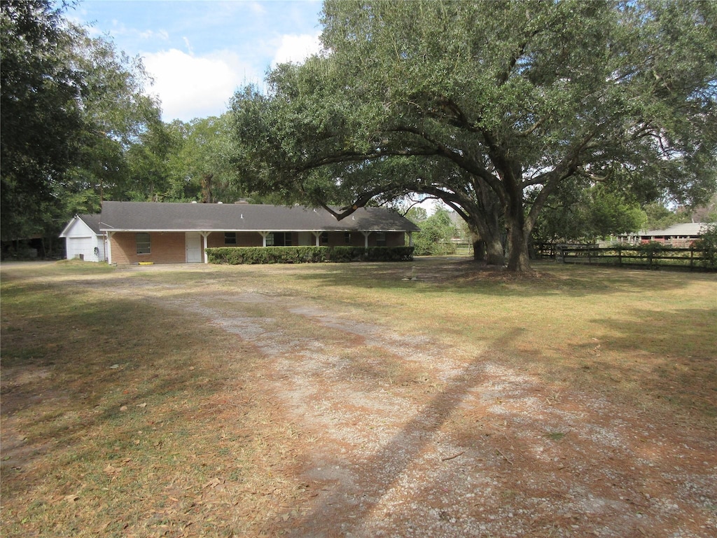 view of yard featuring fence and driveway