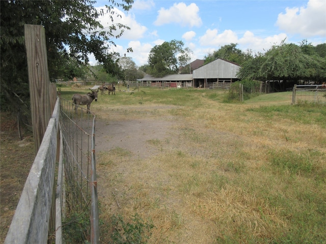 view of yard with a rural view