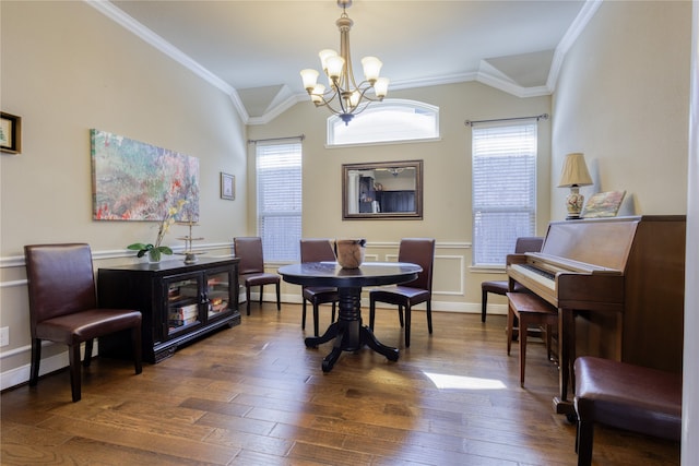 dining area featuring crown molding, a chandelier, and dark hardwood / wood-style flooring