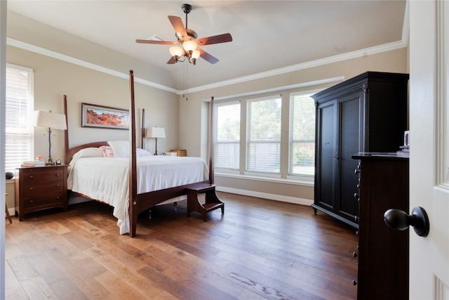 bedroom with multiple windows, ornamental molding, hardwood / wood-style flooring, and ceiling fan