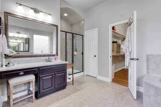 bathroom featuring vanity, tile patterned floors, and an enclosed shower