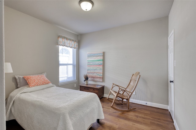 bedroom with hardwood / wood-style floors