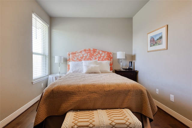 bedroom featuring multiple windows and hardwood / wood-style floors