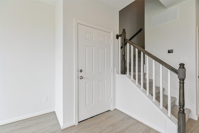 entrance foyer featuring baseboards, visible vents, and light wood finished floors