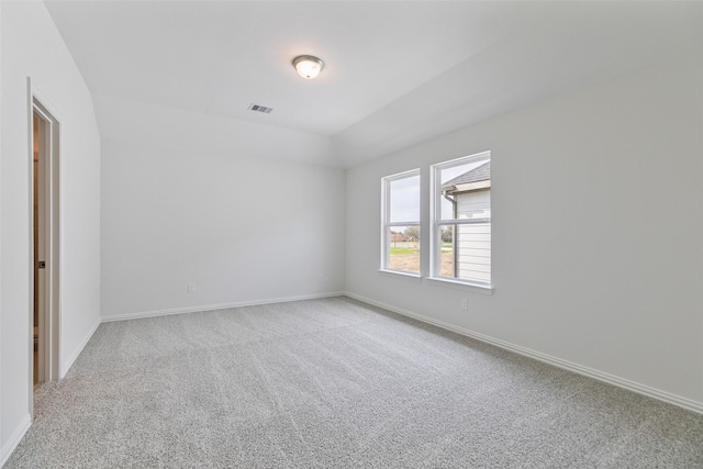 carpeted empty room with visible vents and baseboards