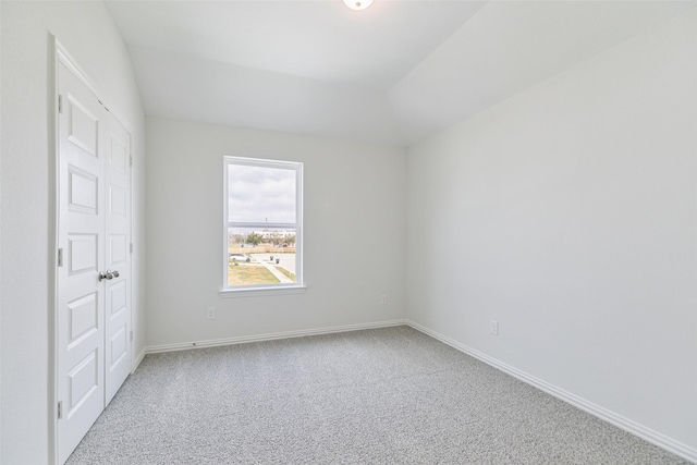 carpeted empty room with baseboards