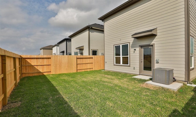 view of yard featuring central air condition unit and a fenced backyard