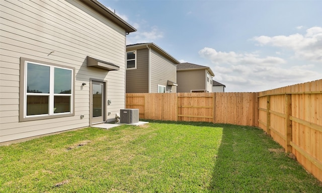 view of yard with cooling unit and a fenced backyard