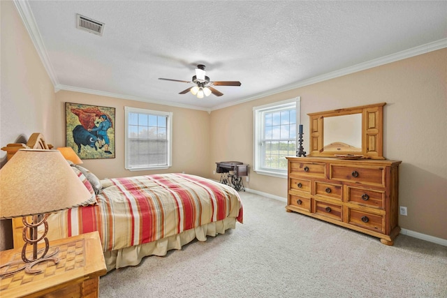 carpeted bedroom with a textured ceiling, ceiling fan, and crown molding