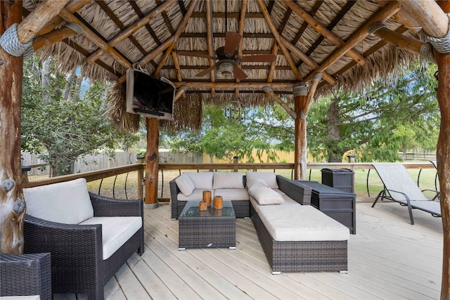 deck featuring ceiling fan, a gazebo, and outdoor lounge area