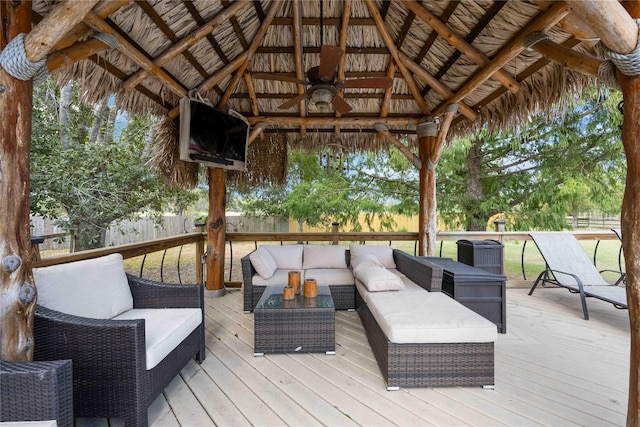 deck featuring ceiling fan, outdoor lounge area, and a gazebo