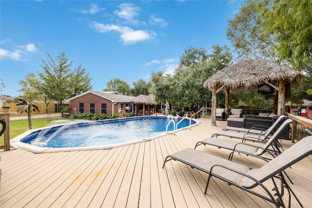 view of swimming pool with a gazebo, an outdoor living space, and a deck