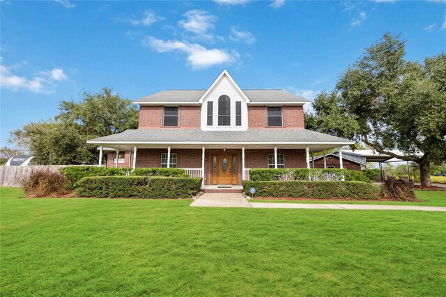 1290 County Road 145, Alvin, TX 77511 - view of front facade featuring a front lawn, a porch, and brick siding