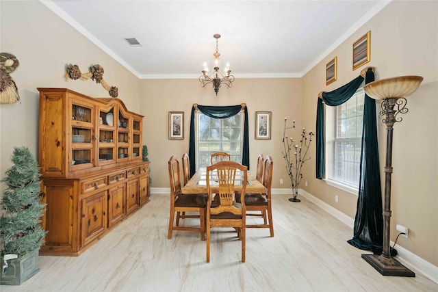 dining room with ornamental molding and a chandelier