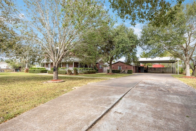 view of front facade featuring a front lawn and a carport