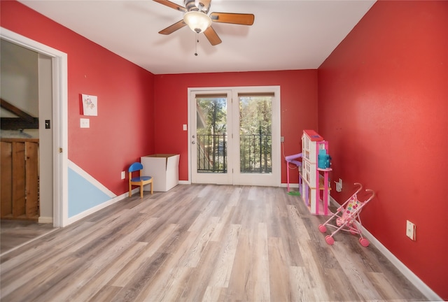 misc room with light wood-type flooring and ceiling fan