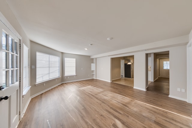 unfurnished living room with wood-type flooring