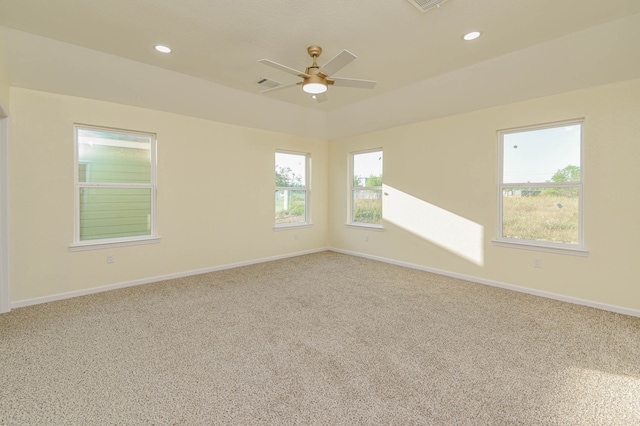 carpeted spare room featuring ceiling fan