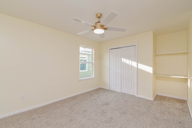 unfurnished bedroom featuring a closet, ceiling fan, and light colored carpet