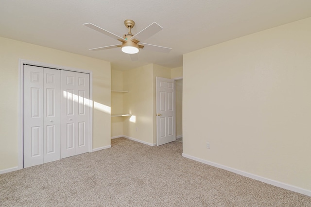 unfurnished bedroom with light carpet, a closet, and ceiling fan