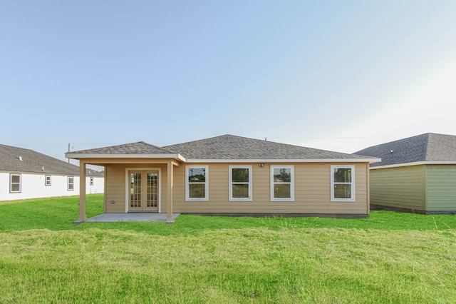 back of property featuring french doors, a patio area, and a lawn