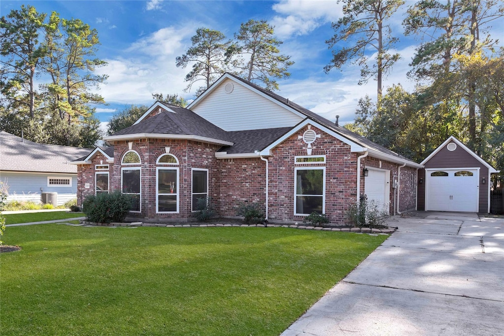 view of front of home with a front yard and central air condition unit